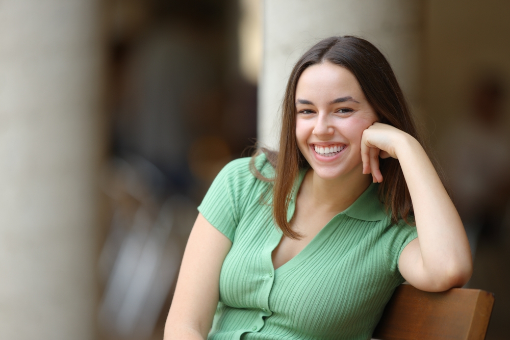 A relaxed woman smiling comfortably, symbolizing reduced dental anxiety and improved confidence following sedation dentistry care – Sedation Dentistry