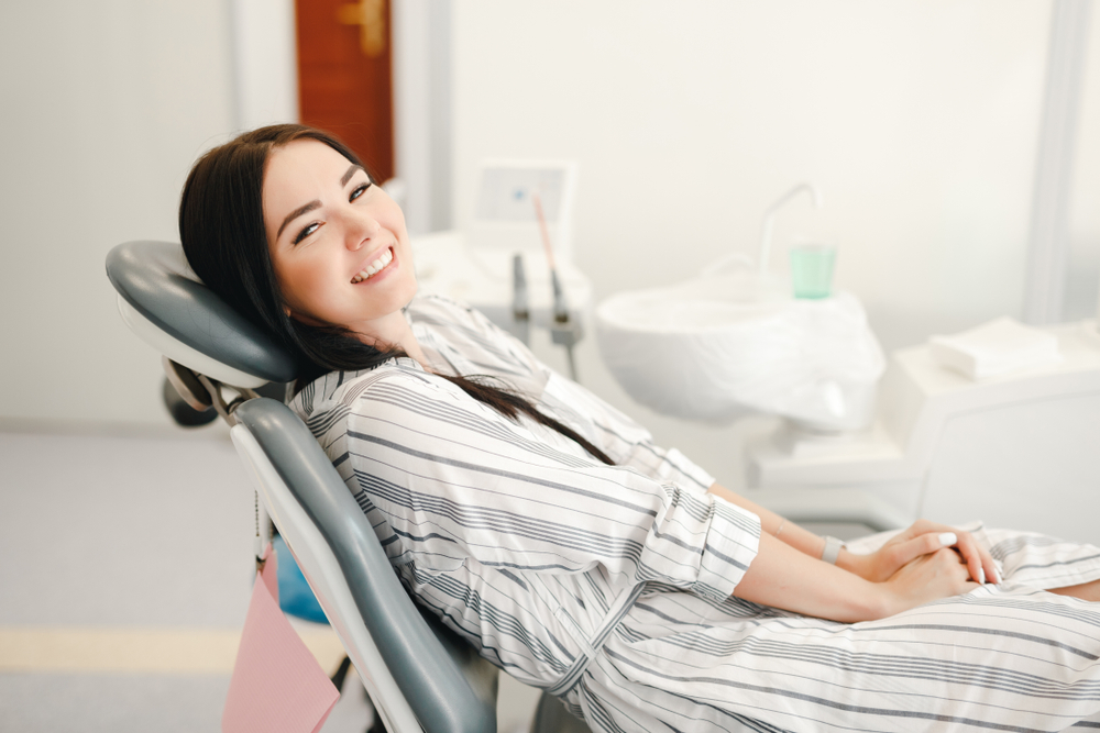 Relaxed Patient Enjoying Cosmetic Dentistry Visit – Cosmetic Dentistry A smiling patient reclining comfortably in a dental chair, highlighting stress-free care and confidence during cosmetic dentistry treatment – Cosmetic Dentistry