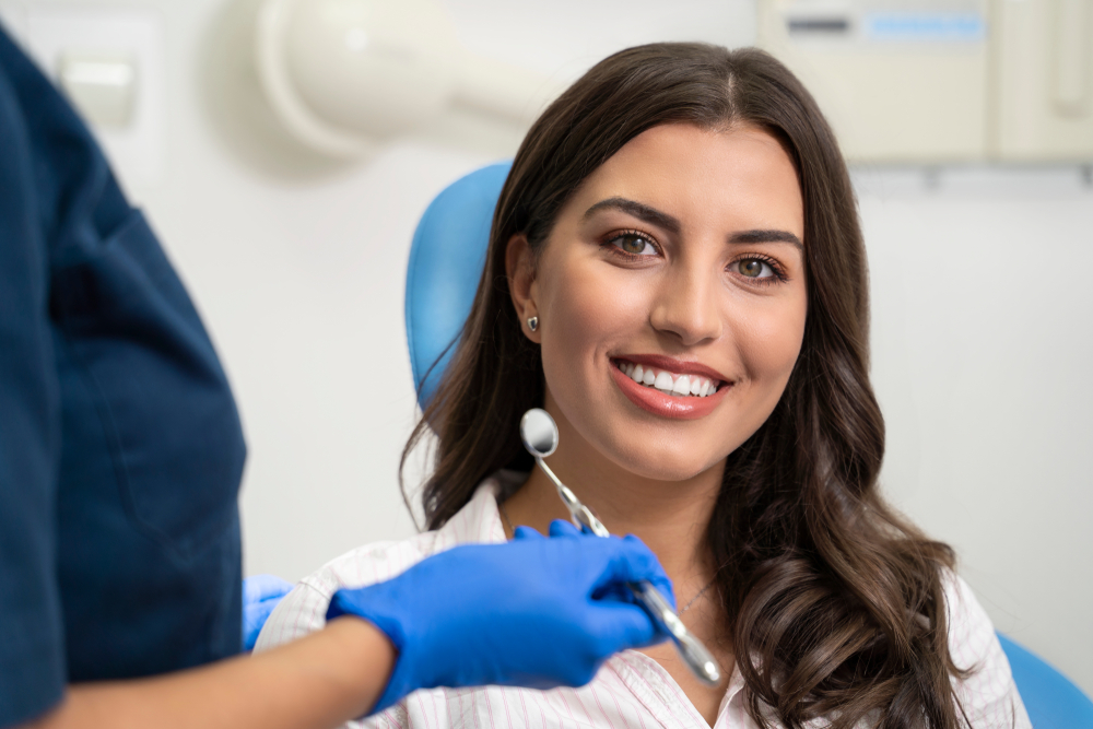 A smiling patient seated in a dental chair during an orthodontic visit, highlighting comfort, trust, and personalized orthodontic care – Orthodontics