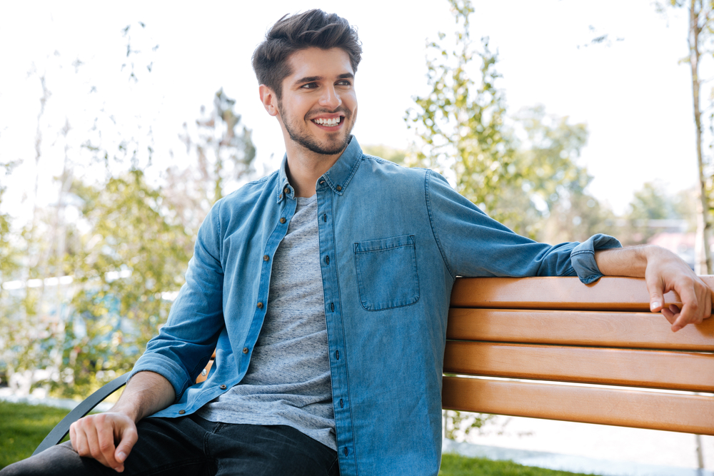A happy, relaxed man enjoying life outdoors, representing renewed confidence and peace of mind after sedation dentistry treatment – Sedation Dentistry
